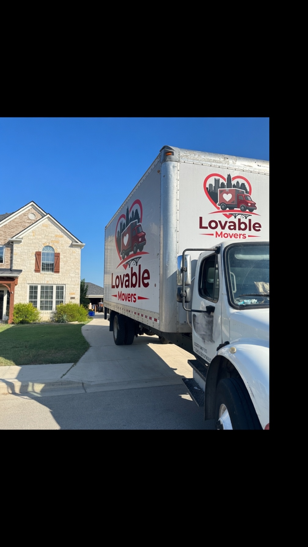 Lovable Movers white box truck parked at a customer's Austin-area home, ready to load